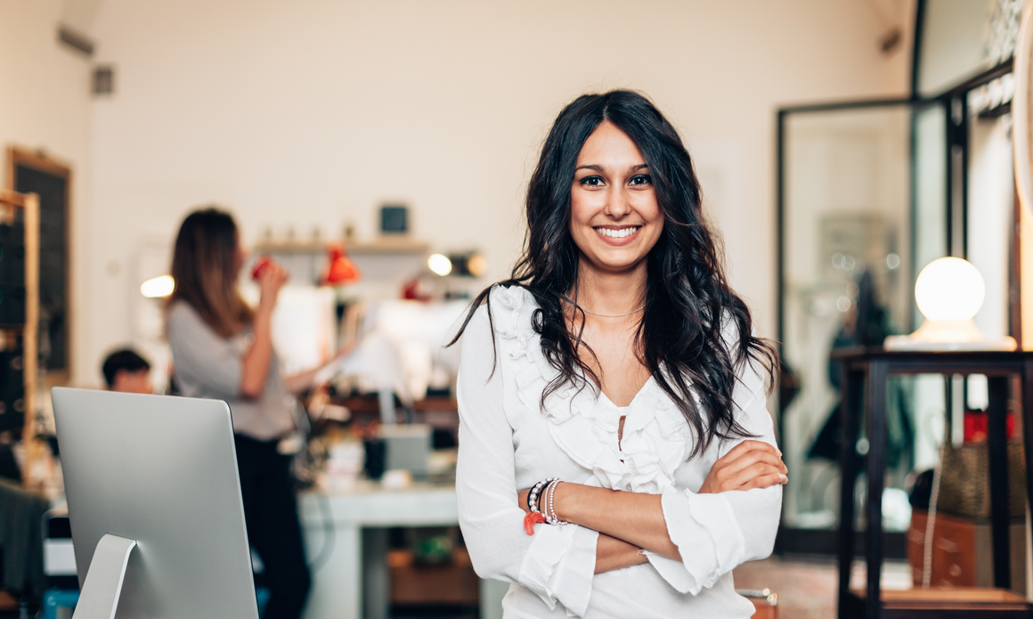 businesswoman smiling at the camera in office showing leadership competencies
