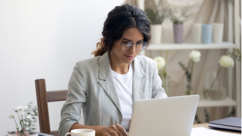 Business woman looking at laptop in office