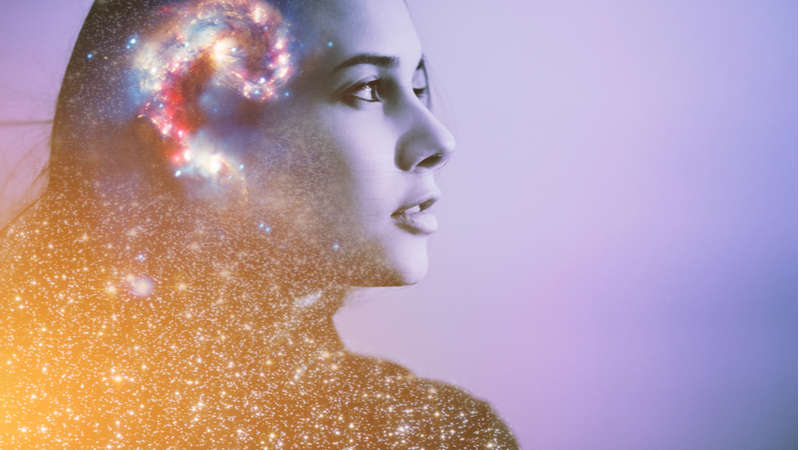 woman thinking and looking into the distance with a galaxy overlay